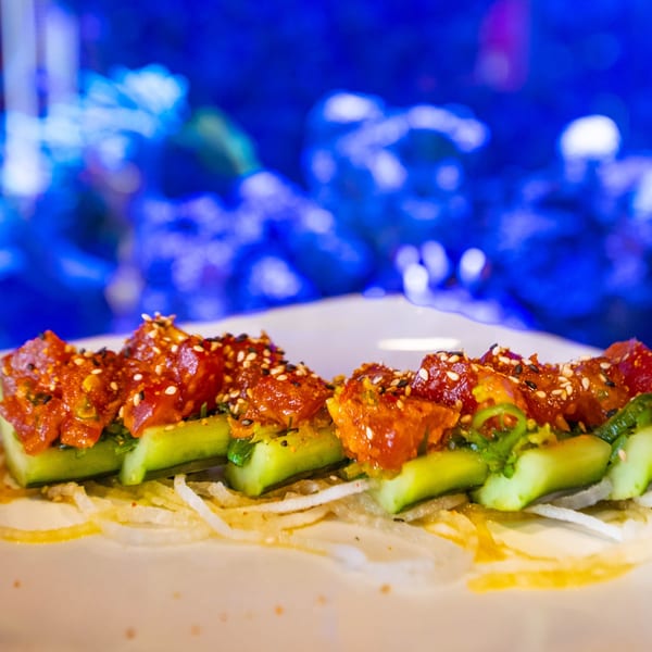 Hot Tuna Sushi Bar and Grille's spicy tuna sashimi on cucumber slices, garnished with sesame seeds.