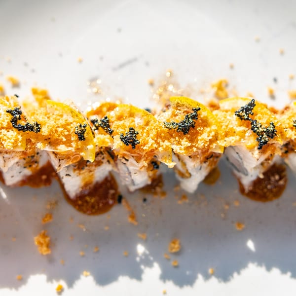 Hot Tuna Sushi Bar and Grille's sushi roll with golden topping, black caviar, and sauce.