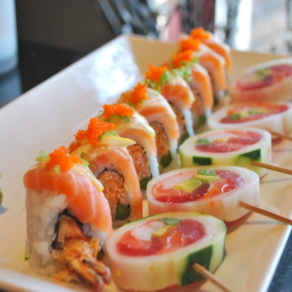 A platter of Hot Tuna Sushi Bar and Grille's sushi rolls, topped with salmon and roe.